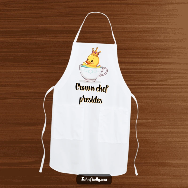 Funny rubber duck wearing a tiny crown doing kitchen tasks with an apron, gift.