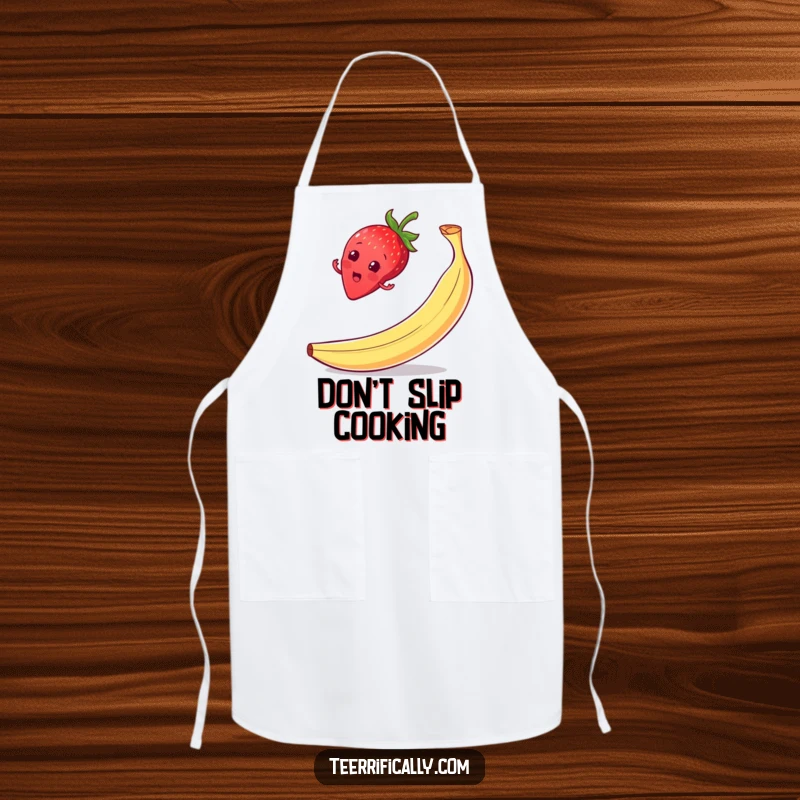 Funny strawberry balance apron, on a banana peel with a surprised grin, perfect for kitchen tasks with humor.