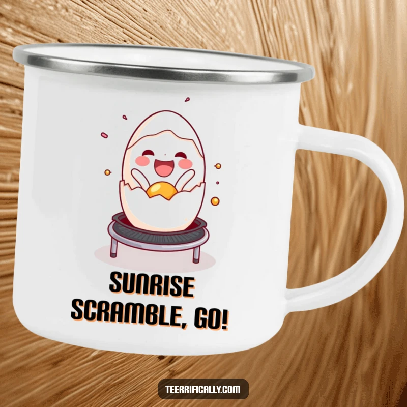 Funny cracked egg camping mug, joyfully spilling onto a trampoline, perfect for outdoor breakfast enjoyment and humor. Durable item.