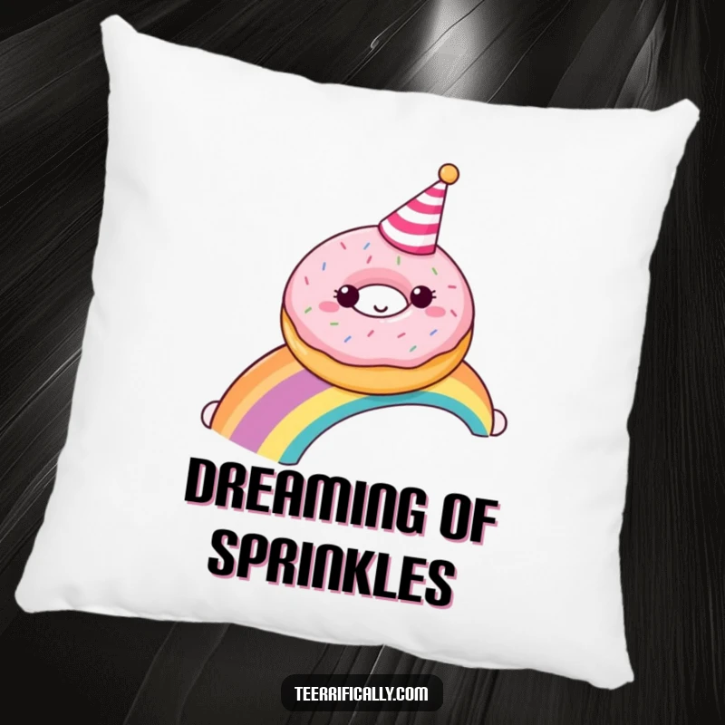 A happy donut with a party hat sliding down a rainbow, depicted on a soft, decorative pillow.