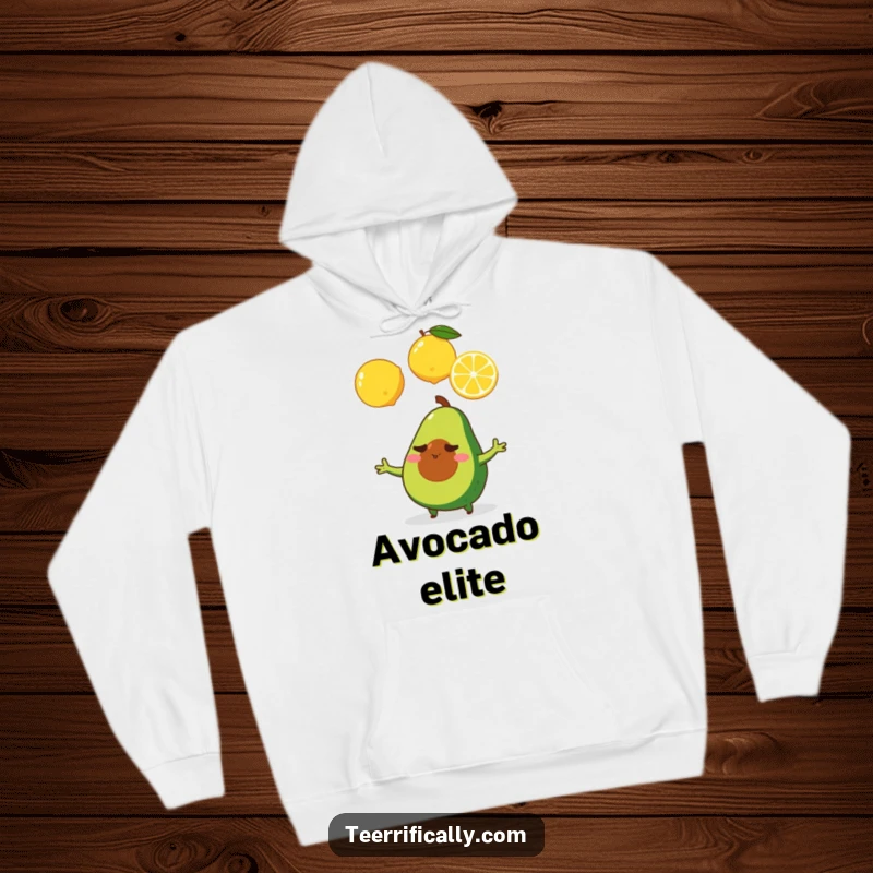 A determined tiny avocado juggling three lemons, featured on a warm hoodie, inspiring focus and effort.