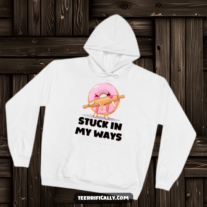 Funny hoodie featuring a clumsy donut hugging a rolling pin, offering warmth and delightful baking humor.