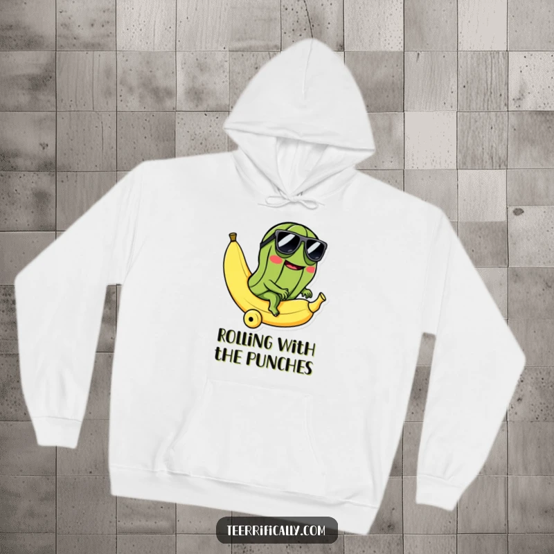 Funny hoodie featuring a cool pickle in sunglasses riding a rolling banana, offering warmth and absurdly humorous style.