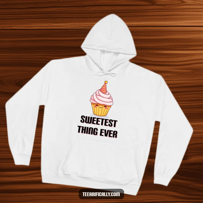 Funny Hoodie showcasing a proud cupcake character adorned with a party hat and overflowing frosting, perfect for festive warmth.