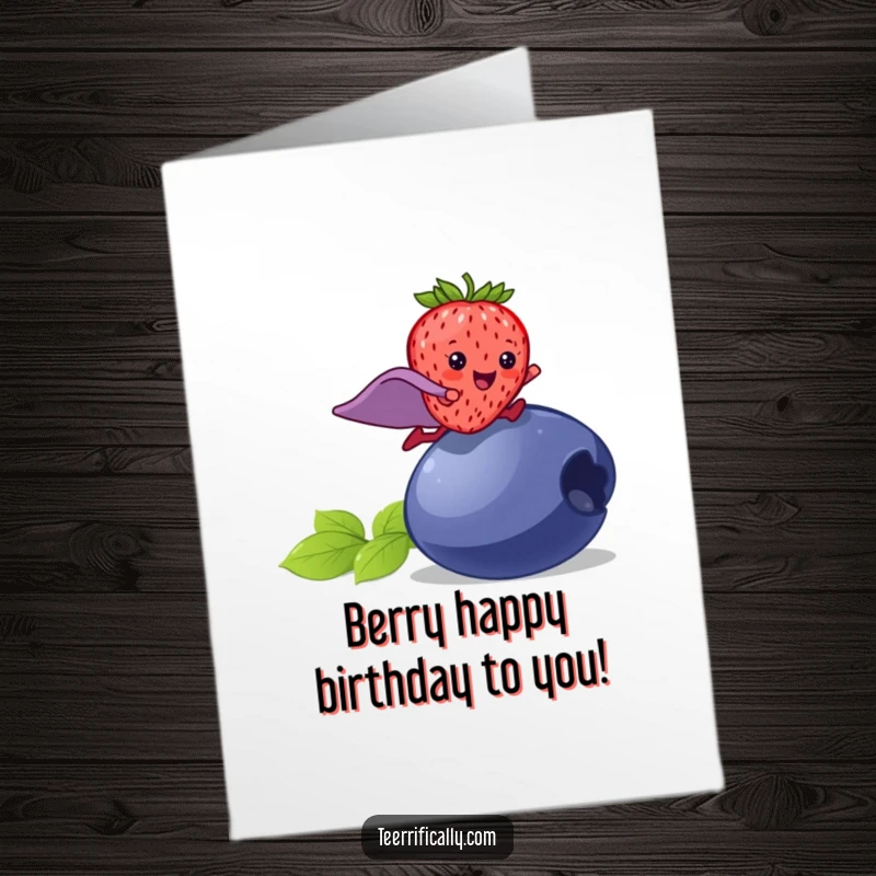 Funny Free Printable Birthday Card: A happy strawberry with a superhero cape leaps over a large blueberry for a birthday adventure.