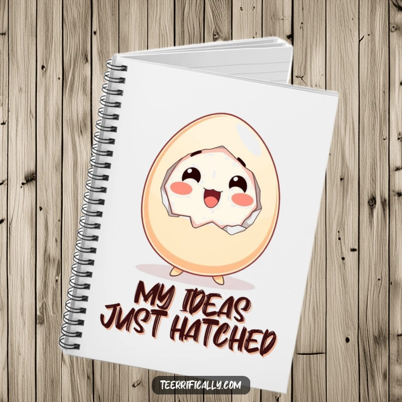 Funny notebook cover featuring a cartoon egg cracking itself open with an expression of happy, delightful surprise.