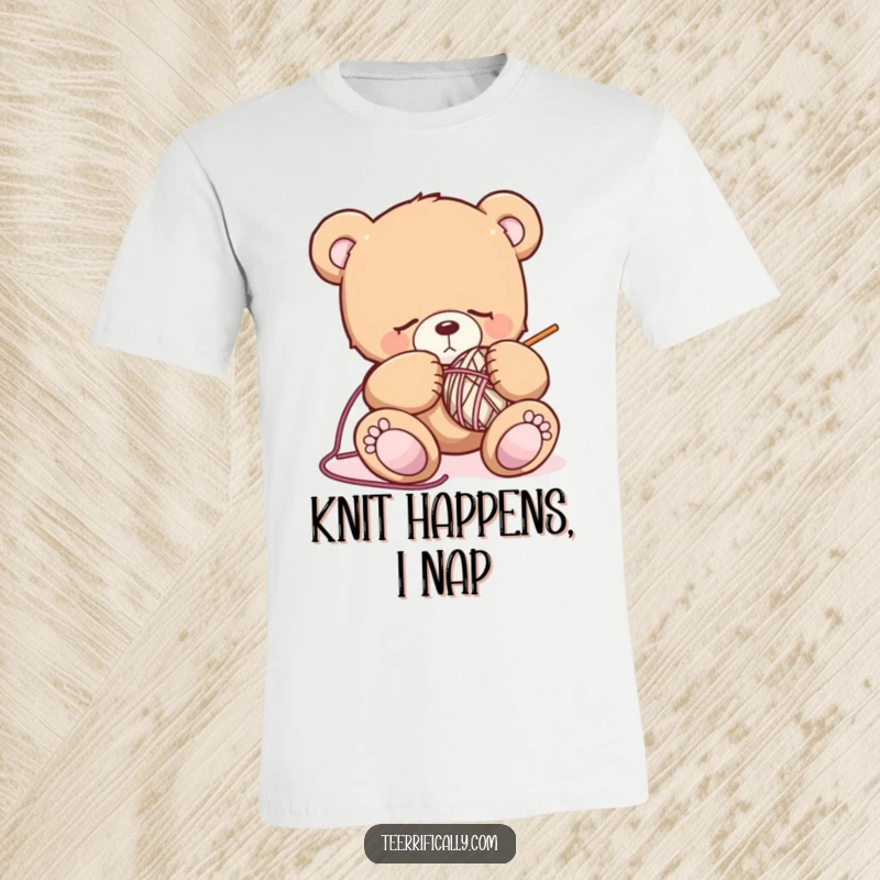 Funny sleepy teddy bear t-shirt depicting a drowsy bear with knitting needles and yarn, illustrating a humorous and cozy crafting session.