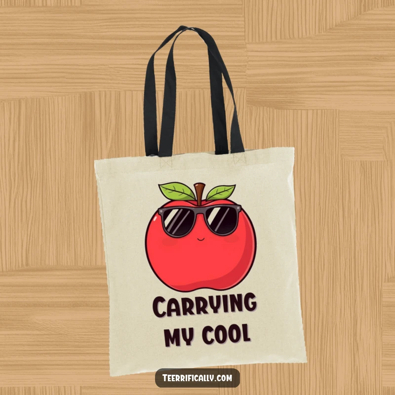 Funny apple tote bag showing a plump red apple in sunglasses winking slyly, perfect for carrying essentials with style.